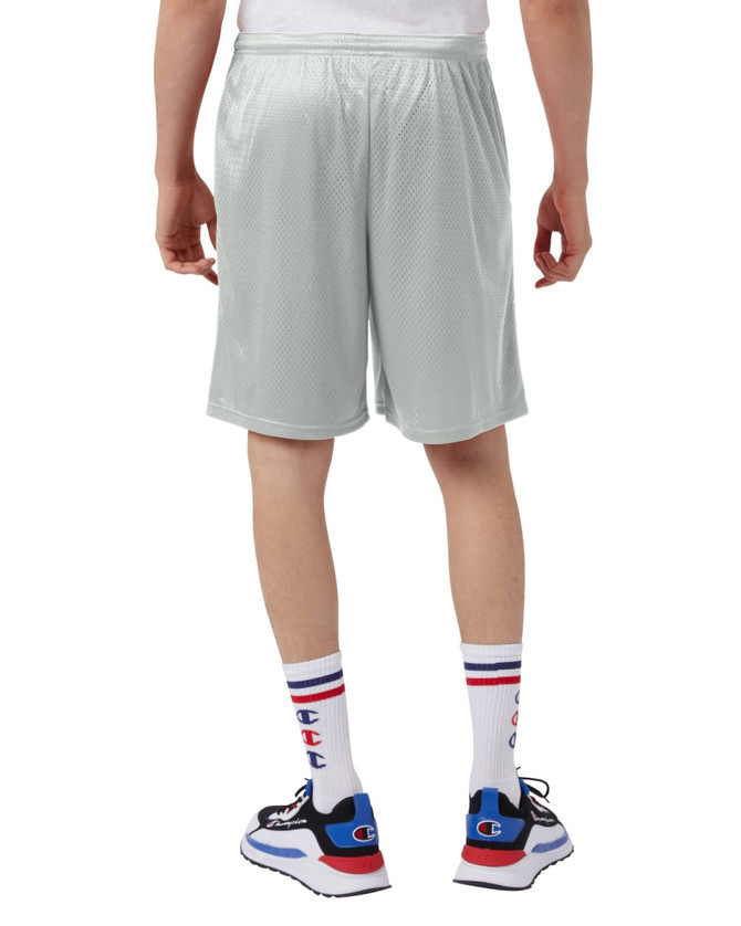 A person wearing light grey athletic shorts, paired with colourful socks and sneakers, viewed from the back.