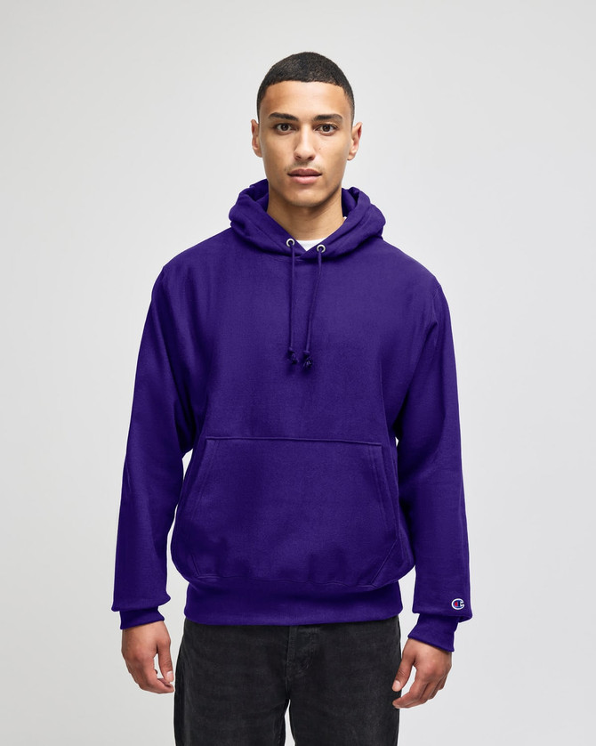 A purple pullover hooded sweatshirt with a front pocket and a logo on the sleeve.