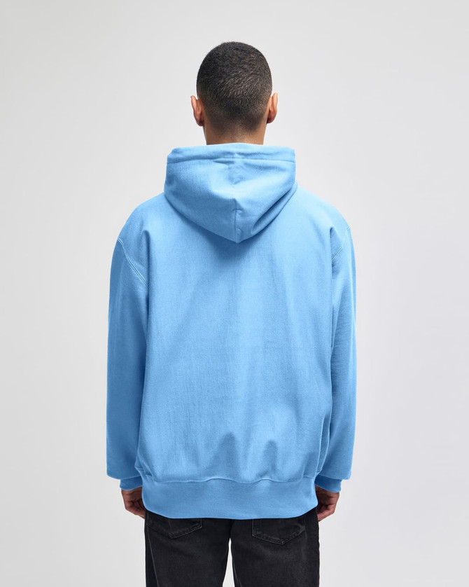 A light blue pullover hooded sweatshirt with a hood and a relaxed fit, featuring a logo on the back.