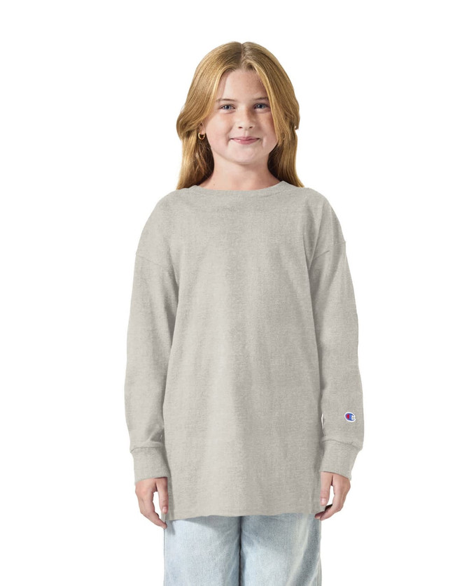 A light grey long sleeve youth t-shirt featuring a logo and relaxed fit.
