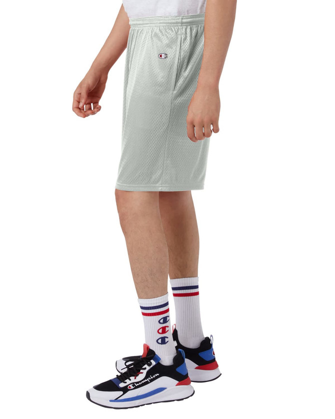 A pair of light grey athletic shorts with an elastic waistband, worn with colourful socks and sneakers featuring a logo.