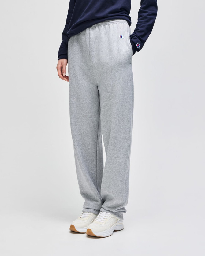 Grey fleece track pants with open bottoms and pockets, featuring a small logo on the side.