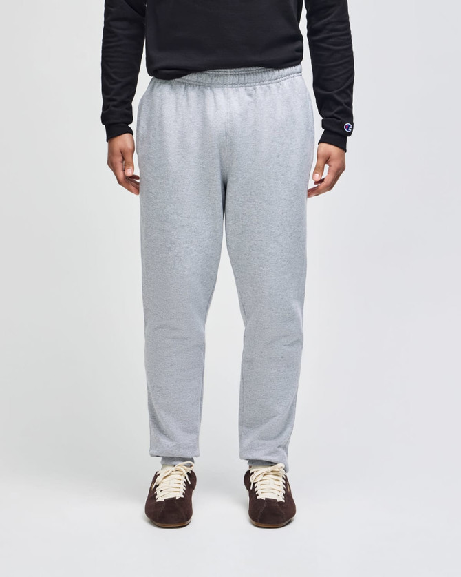 A pair of light grey adult fleece joggers with an elastic waistband and a fitted ankle design.