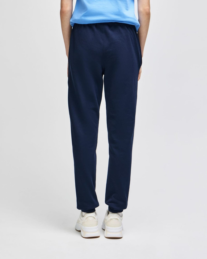 A pair of navy joggers with an elastic waistband, featuring a logo on the back.