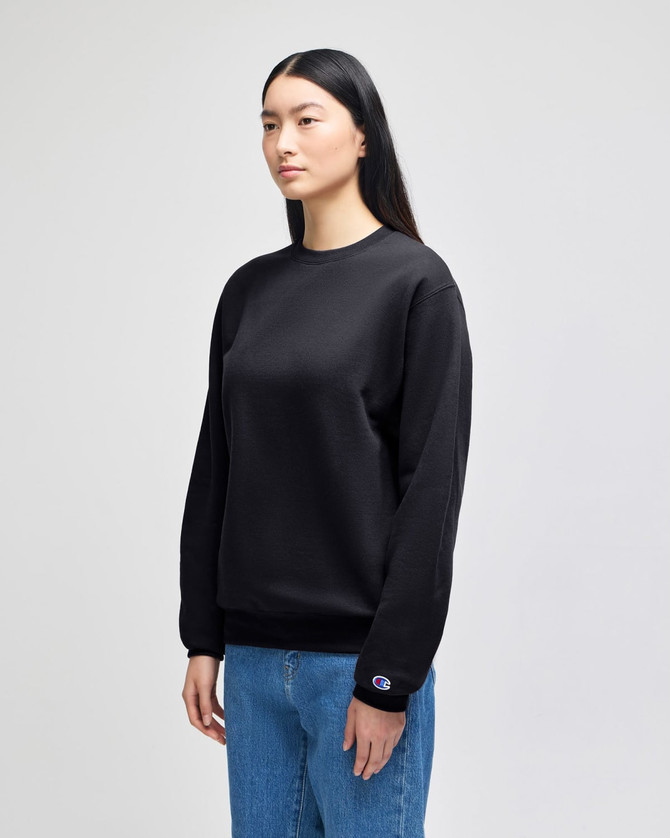 A black adult crewneck sweatshirt, featuring a logo, displayed on a model. The style is casual and sporty.