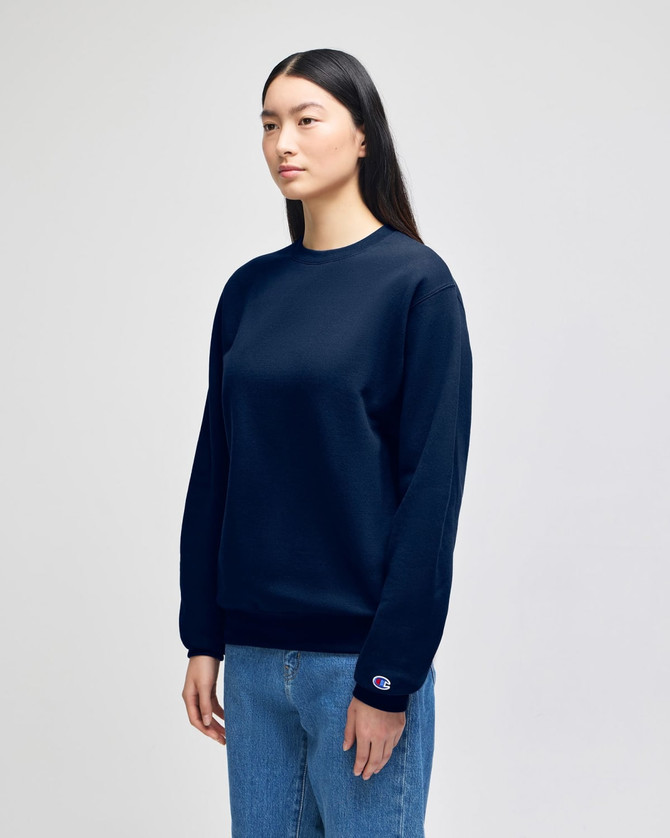 A navy blue crewneck sweatshirt with long sleeves, featuring a logo on one sleeve.