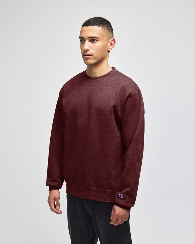 A burgundy crewneck sweatshirt with long sleeves, featuring a logo on the hem.