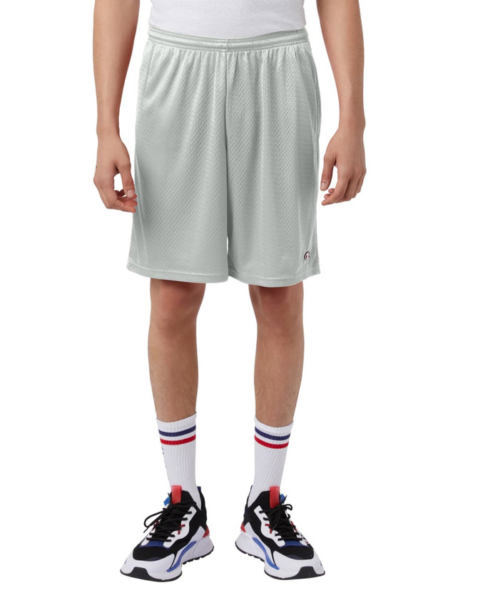 Mesh sports shorts in light grey with pockets, modelled by a person wearing stylish athletic shoes and crew socks.