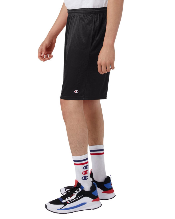 Black mesh sports shorts with pockets, featuring a logo, worn with colourful socks and sneakers.