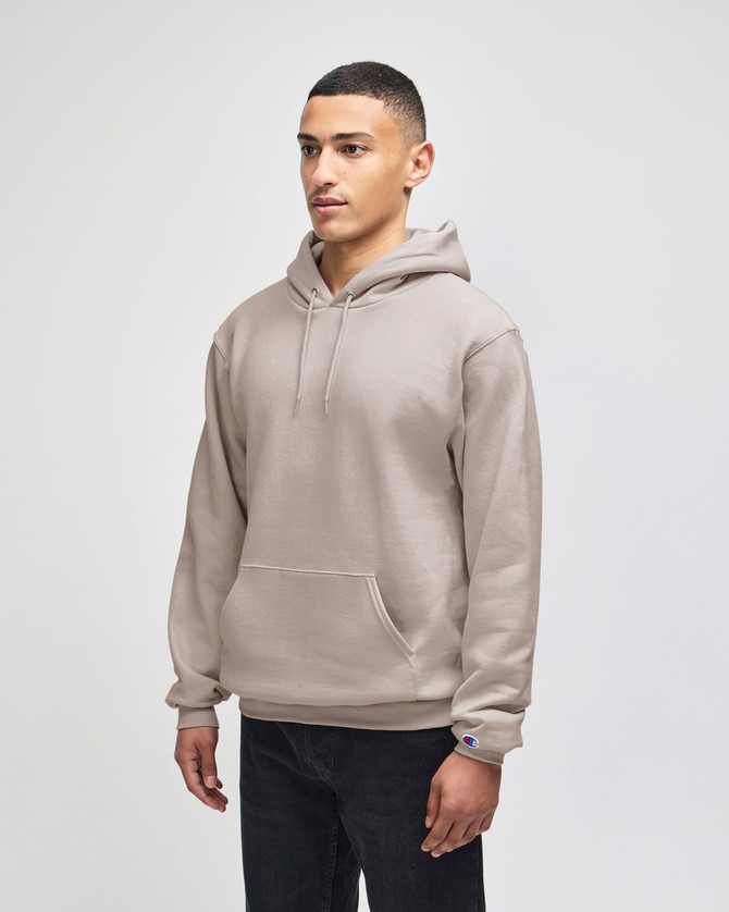 A beige pullover hooded sweatshirt with a front pocket and a logo on the sleeve.