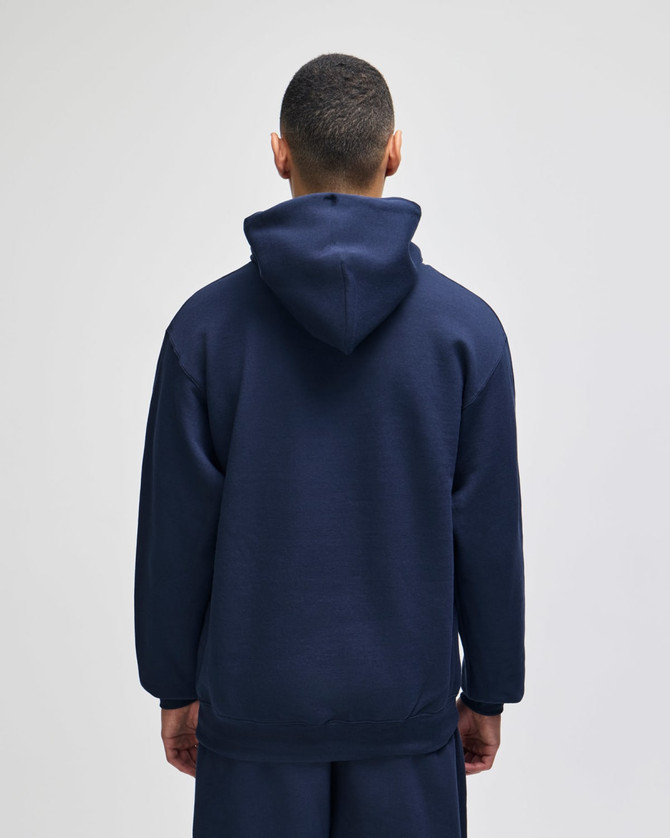 A navy blue pullover hooded sweatshirt viewed from the back, featuring a hood and loose fit.