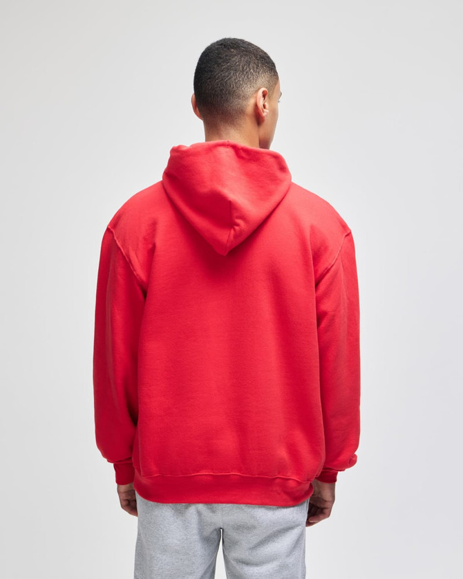 A red pullover hooded sweatshirt with a simple design, featuring a hood and a relaxed fit, viewed from the back.