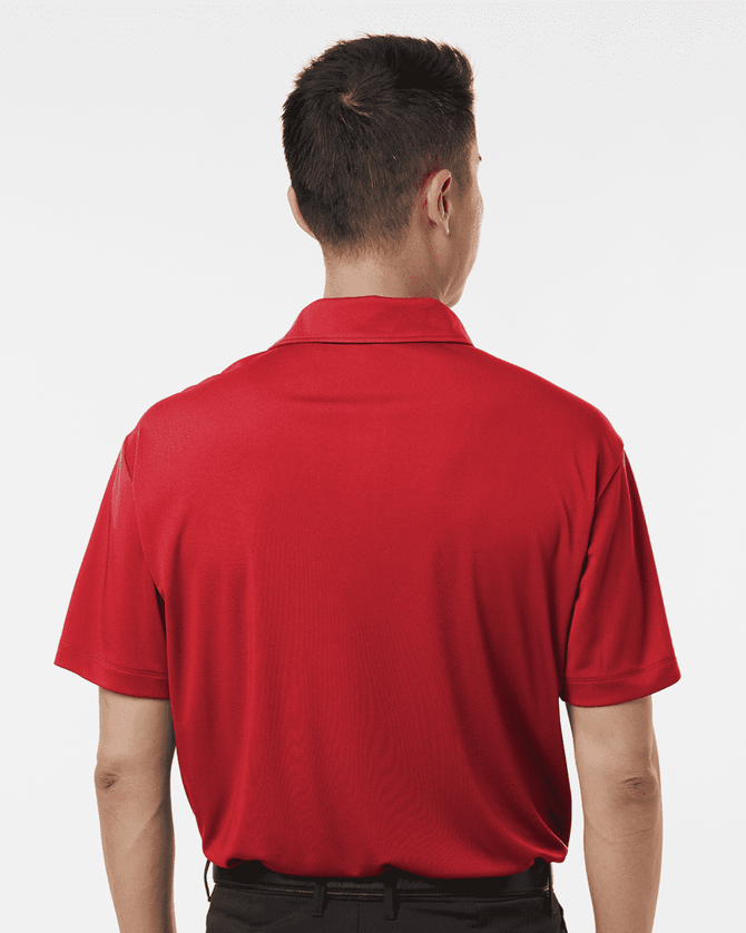 A red men's polo shirt displayed from the back, featuring a collar and short sleeves, with branding.