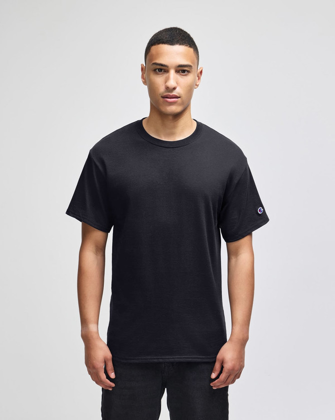 A black short-sleeve t-shirt with a logo on the sleeve, displayed on a model against a plain background.