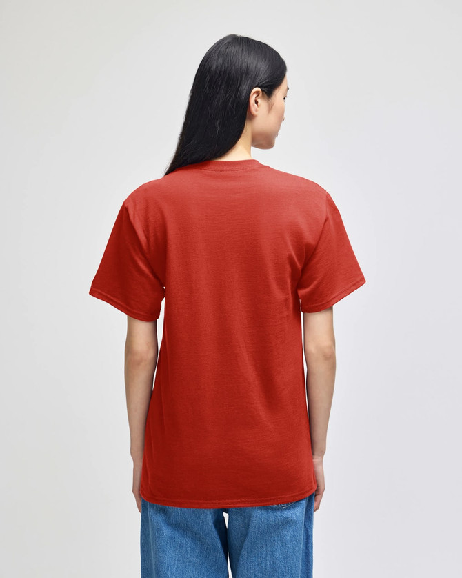 A red Champion adult short-sleeve t-shirt viewed from the back, worn with blue jeans. Features a logo.