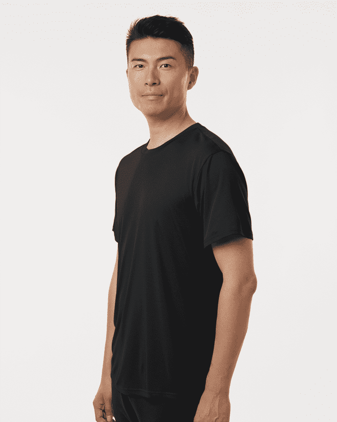 A black men's performance t-shirt displayed on a model, featuring a fitted design and a logo.