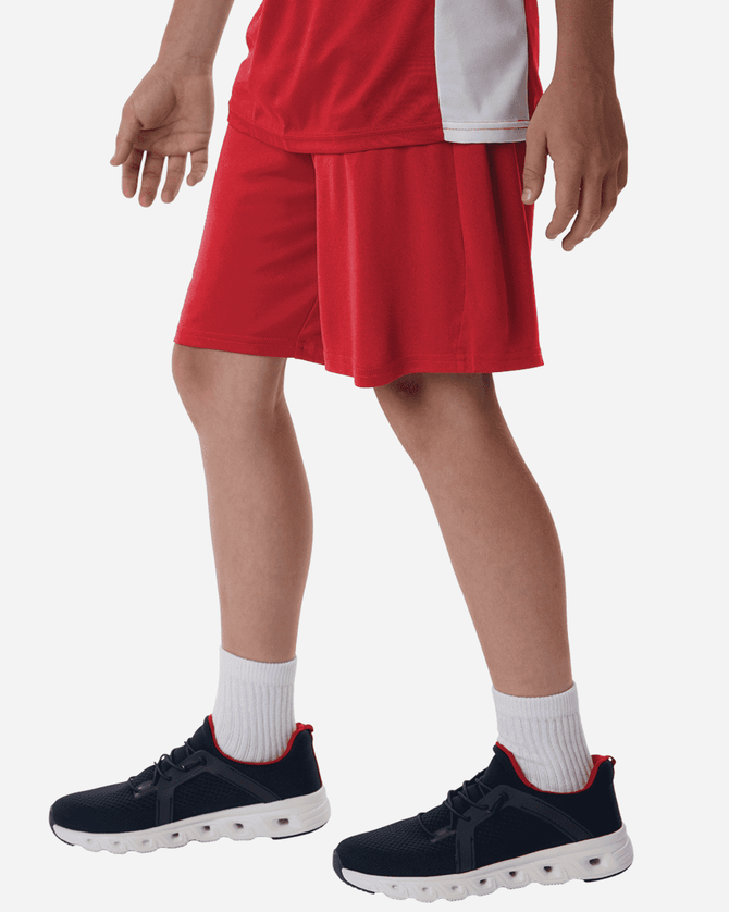 Men's Pro-Lock Performance Short in red, paired with dark sneakers and white socks. Features a visible logo on the shorts.