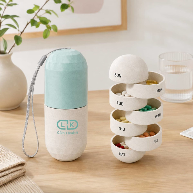 A light blue and white capsule-shaped pill organiser with seven compartments for each day of the week.