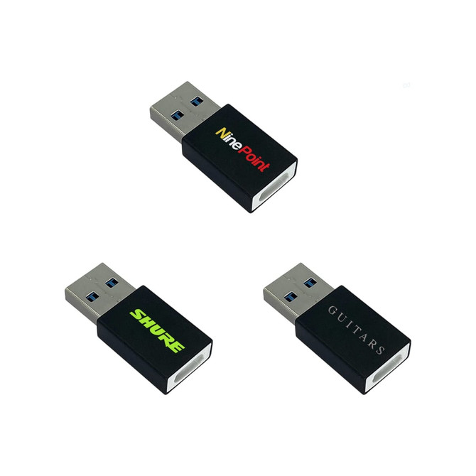 A set of three black USB data blockers with different logos, featuring standard USB connectors.
