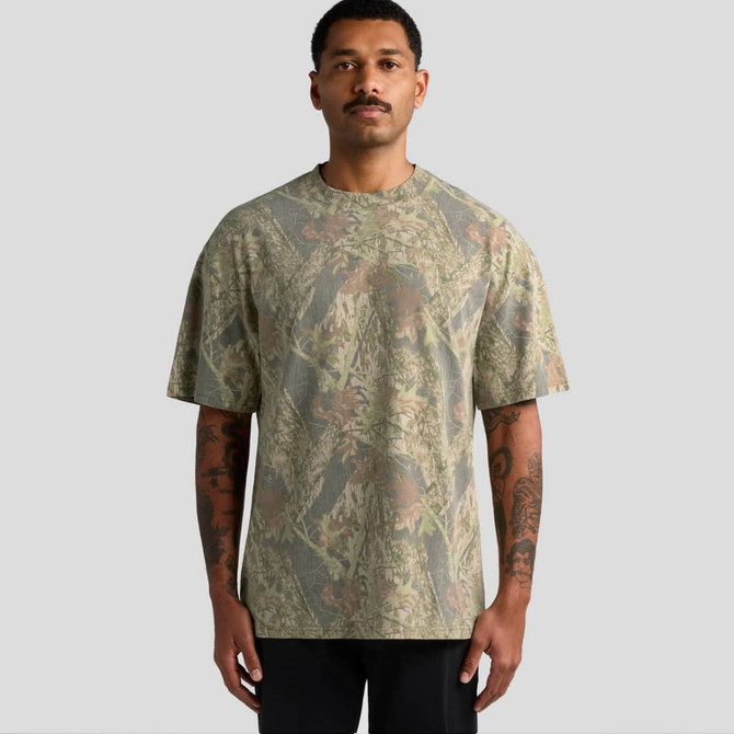 A man wearing a heavy faded camo T-shirt in earthy tones, featuring a camouflage pattern and a relaxed fit.
