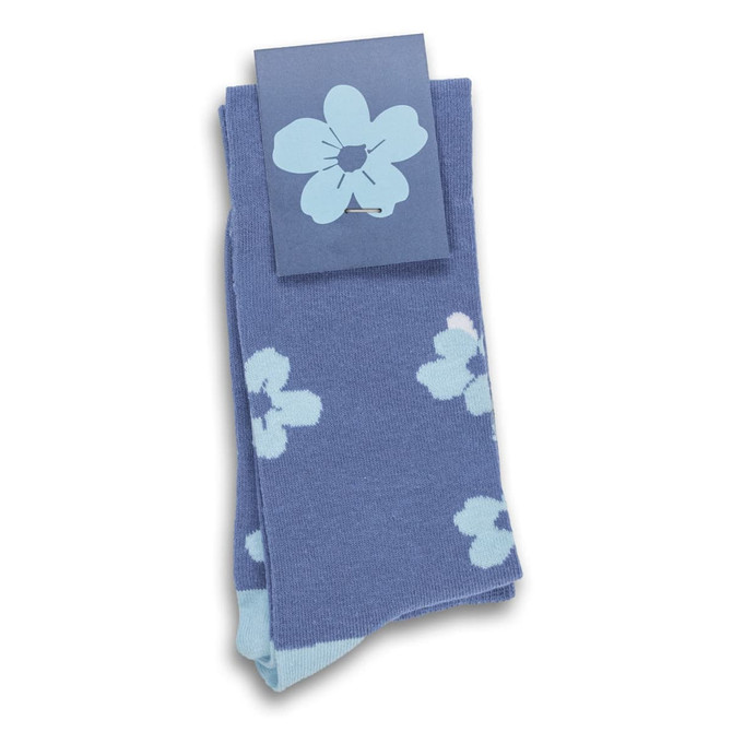 Knee-high socks in blue featuring a floral pattern, packaged with a decorative label.