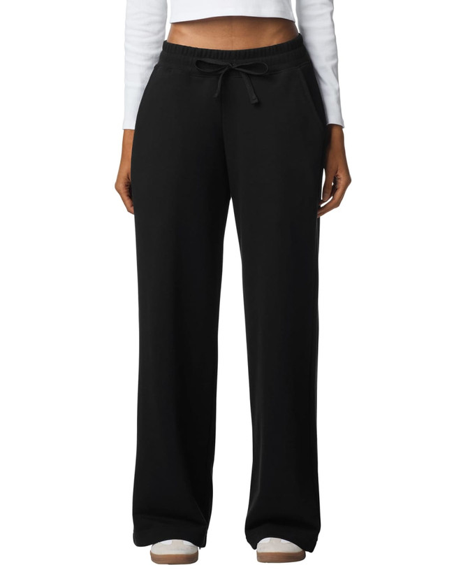 Wide leg pants in black with a drawstring waist, featuring a relaxed fit and pockets. The model is wearing a long-sleeved top.