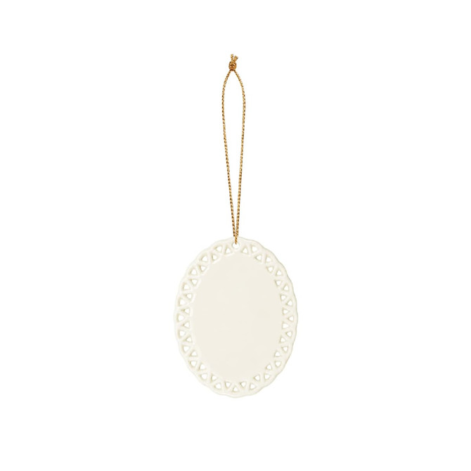 A ceramic ornament in white with a decorative lace-like edge and a gold hanging string.