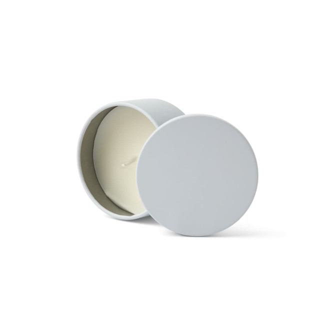 A grey mini tin candle with a white wax interior and a wick, displayed with the lid off.