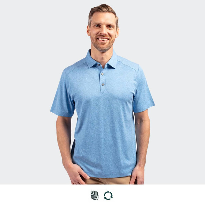 A men's polo in light blue, featuring a collar, buttons, and a logo. Model is smiling and standing.