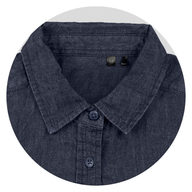 A close-up of a dark denim button-up shirt with a collar and navy buttons. The shirt has a logo tag inside.