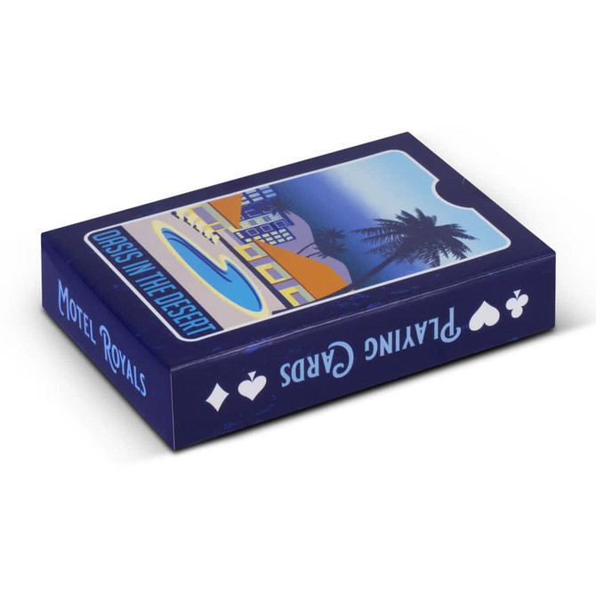 A blue playing card deck featuring a design of a motel and palm trees. The box has a logo and artistic details.