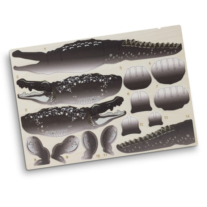 A wooden model kit featuring a crocodile design, with various parts in dark and light shades on a beige background.