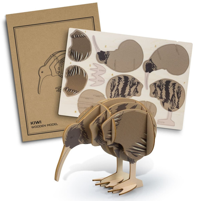 A kiwi wooden model in natural tones with a packaging sheet featuring assembly instructions and templates.