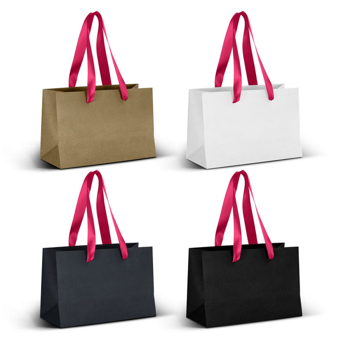 A series of four small ribbon handle paper bags in gold, white, navy, and black with pink handles.