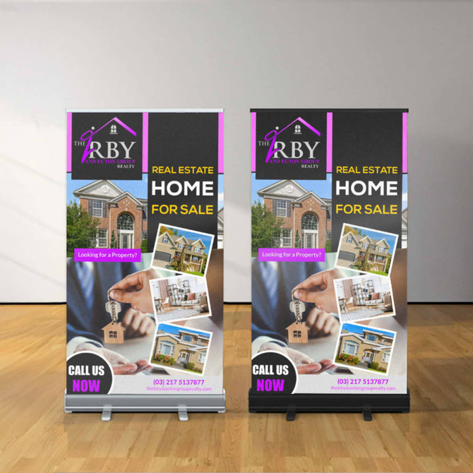 A pull-up banner featuring a real estate theme, predominantly in black and white with colourful images, and a logo.