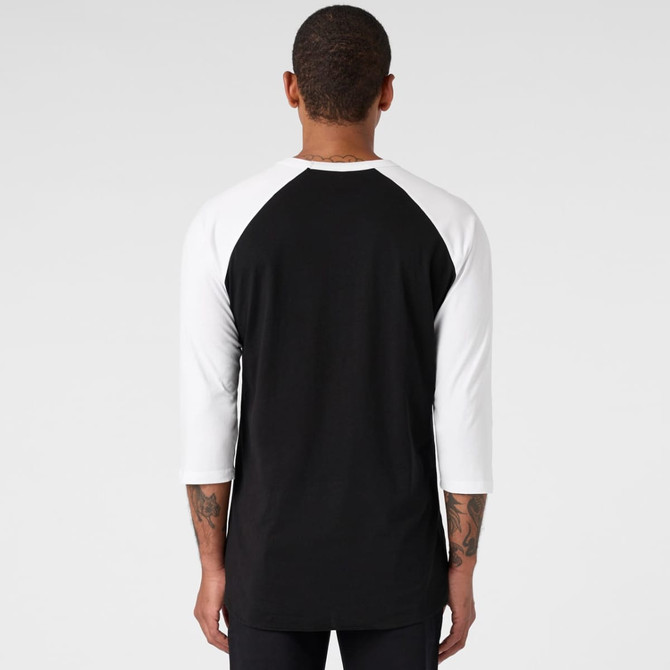 A black and white raglan tee with three-quarter sleeves, featuring a logo on the back.