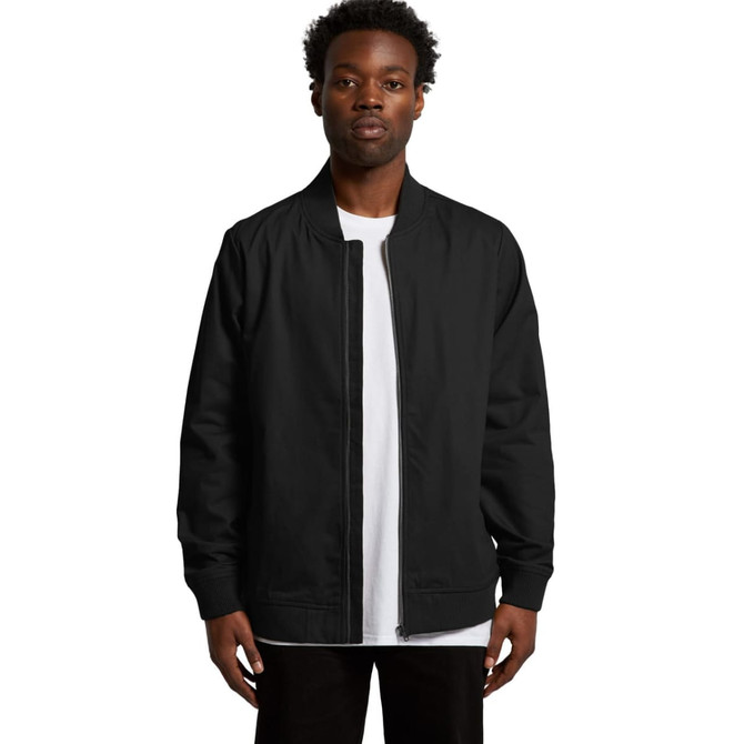 A black bomber jacket is displayed on a model, featuring a zip front and ribbed cuffs. The jacket has a logo.