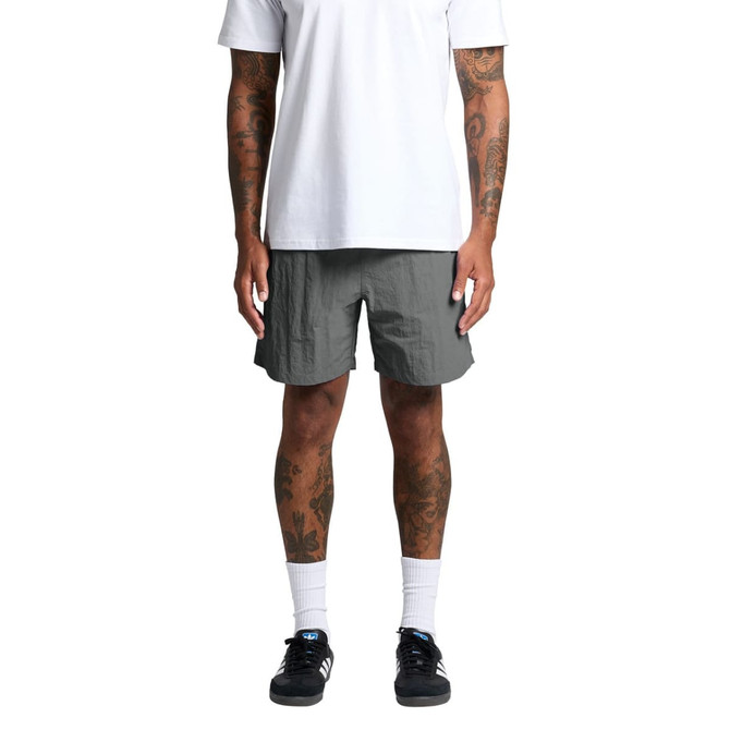A pair of grey swim shorts with a loose fit, featuring an elastic waistband and a logo detail.