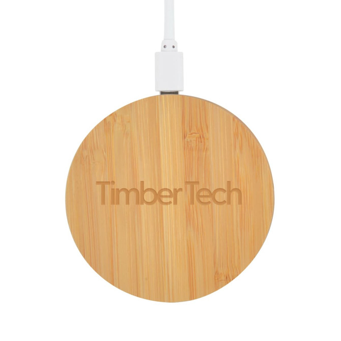 A round bamboo wireless charger in natural wood finish, featuring a logo and connected to a white charging cable.