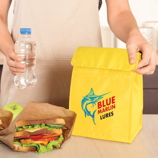 A yellow cooler lunch bag with a logo, alongside a water bottle and sandwiches in brown paper bags.