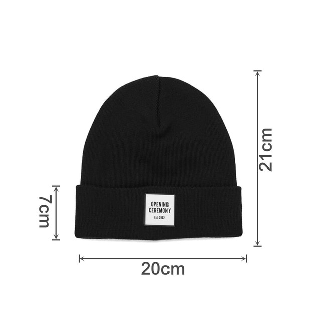 A black knitted beanie with a fold-up cuff and a label, measuring 20cm wide and 21cm tall.