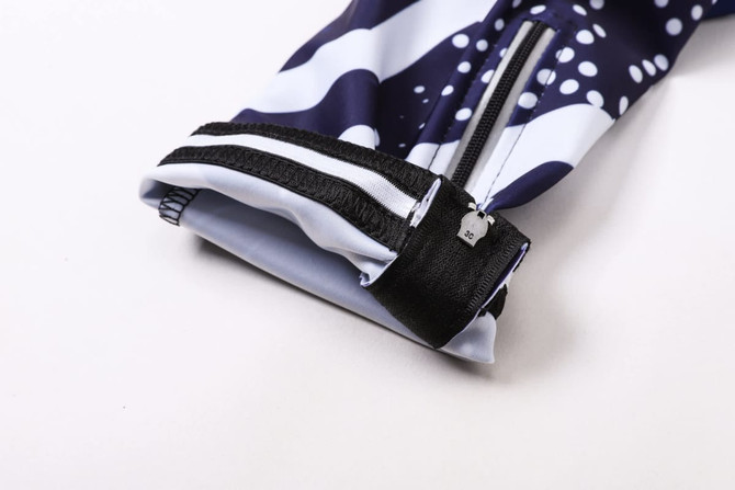 Men's cycling bib tights featuring a navy blue and white design, with a zip and an adjustable cuff. Includes branding.
