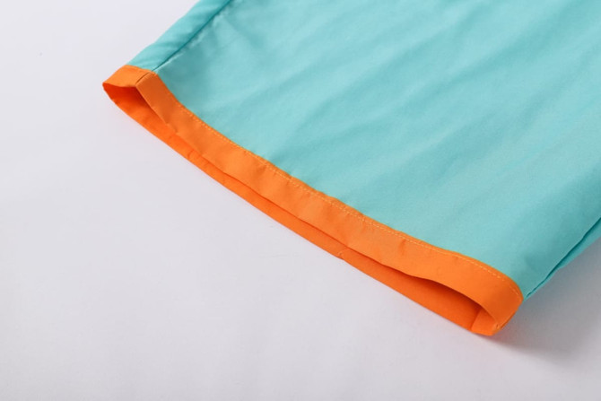 Men's polyester beach shorts in a turquoise colour with an orange trim at the hem. Features a logo.