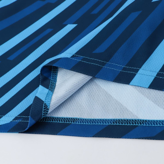 A patterned singlet featuring shades of blue and light blue, made from 100% polyester with a logo present.