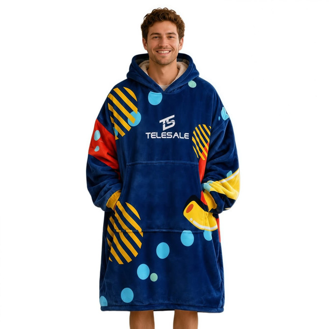 A vibrant blue wearable blanket featuring multicoloured patterns and a hood, made from 100% polyester with an absorbent lining.