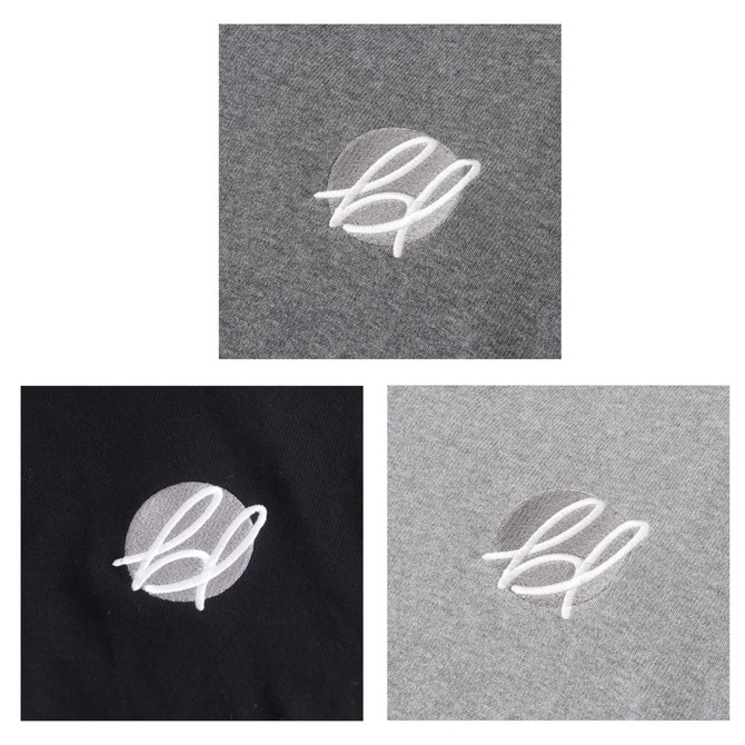 A patch featuring an embroidered logo in white, displayed on grey and black fabric sections.