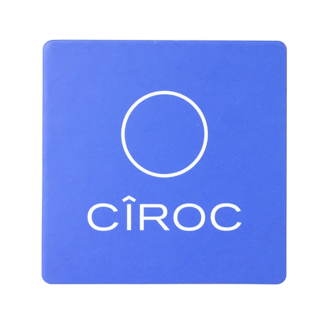 A blue cork coaster with a circular logo and branding.