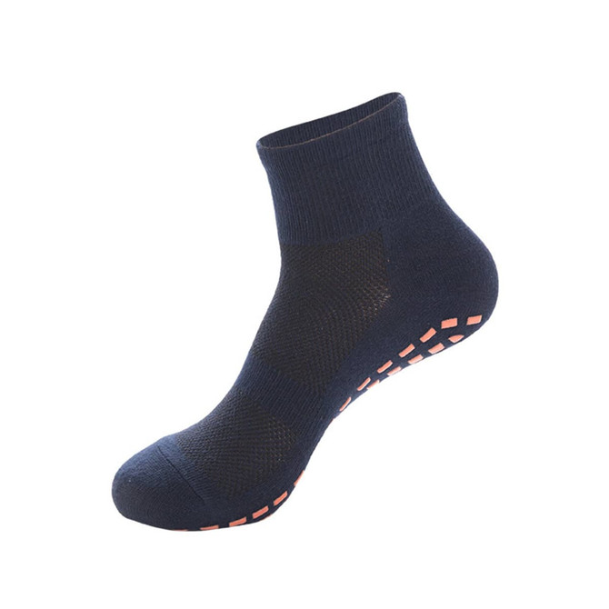 A navy blue crew sock with textured detailing and orange grip on the sole. Features a branding logo.