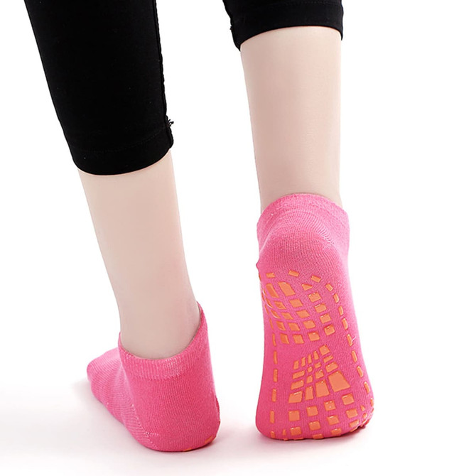 Low cut pink kids' gripper socks with non-slip sole patterns, ideal for added traction.