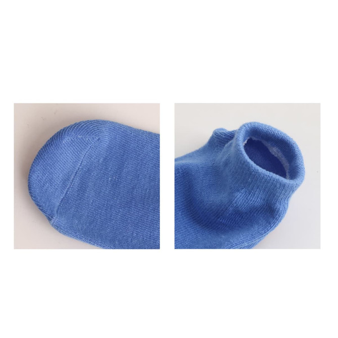 Blue low cut socks with gripper soles, featuring a simple design. The image displays both the toe and ankle sections.